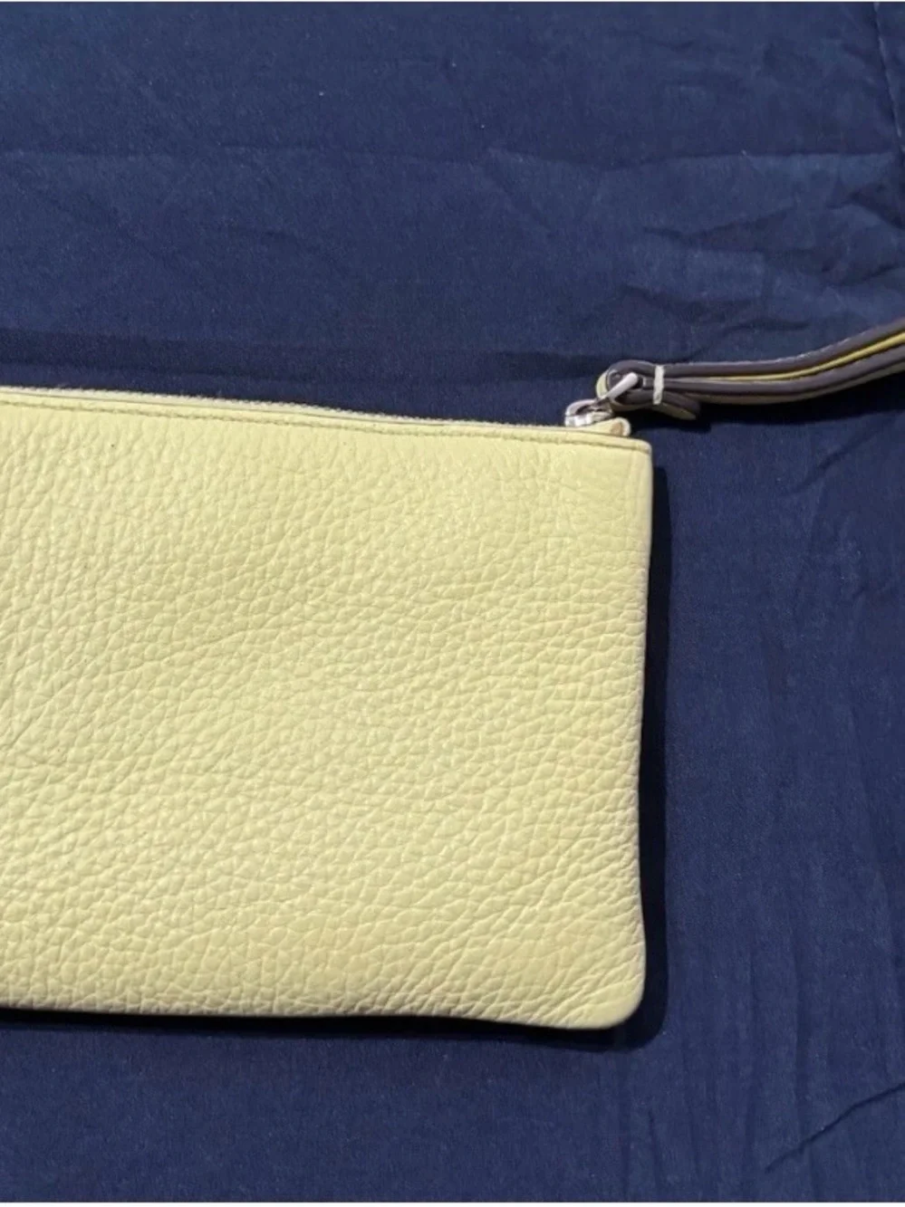 kate spade pale yellow pebbled leather wristlet with striped strap